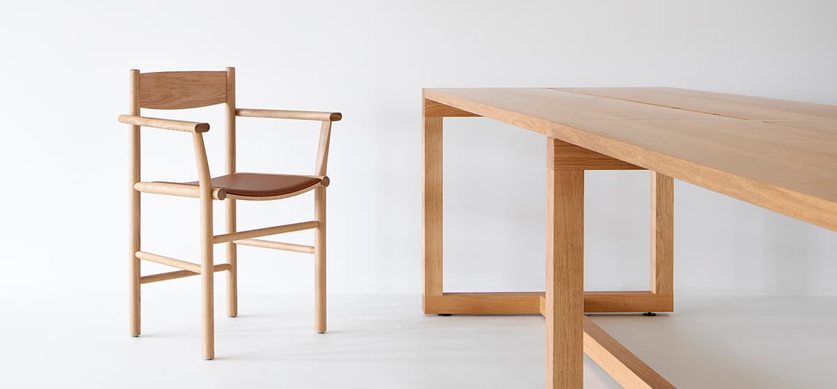 Akademia chair with armrests featuring curved seat and straight frame by Kaksikko for Nikari