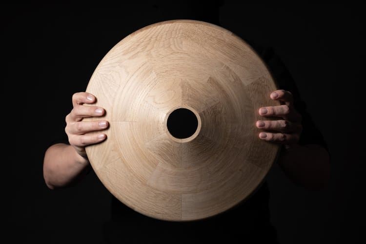 Detail of Pivå table base showing solid wood construction and tree trunk inspired pedestal design
