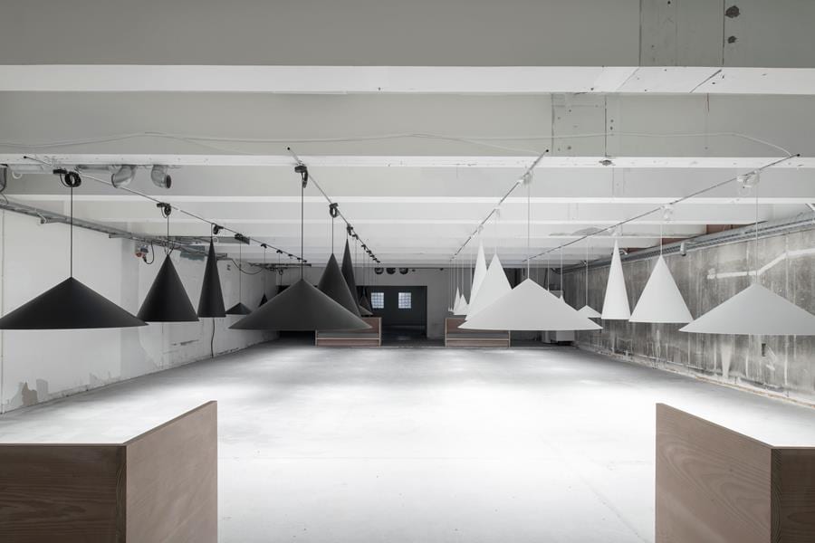 Complete W221 pendant installation showing multiple cone sizes and dramatic spatial lighting effects