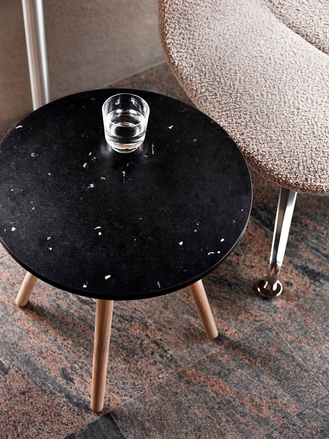 Tinnef table featuring unique recycled plastic top with marbled patterns from waste bottle transformation