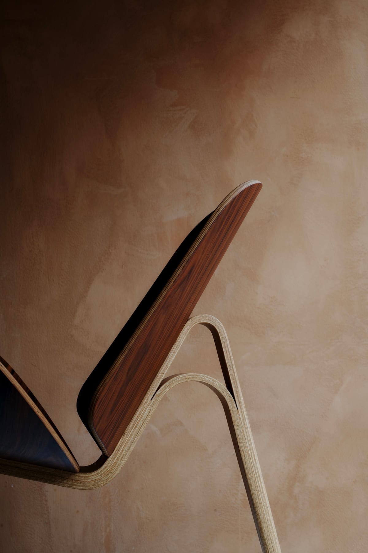 Close-up of Shell Chair joinery showing precision craftsmanship in Wegner's complex wooden structure
