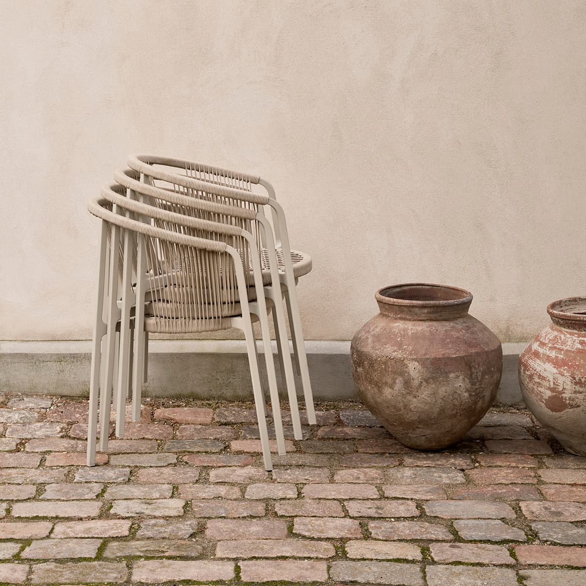 Vipp Lagrasse stackable outdoor chair with lightweight aluminum frame and woven cord detail, perfect for small patios