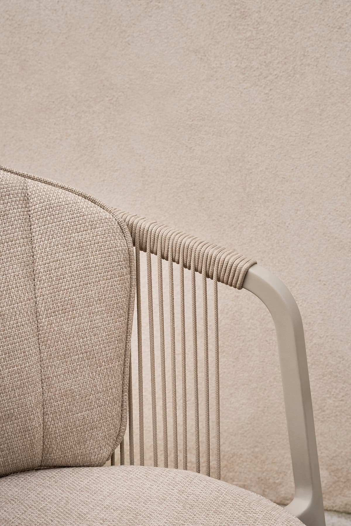 Vipp Lagrasse dining chair with curved backrest extending into armrests, designed for comfortable outdoor use