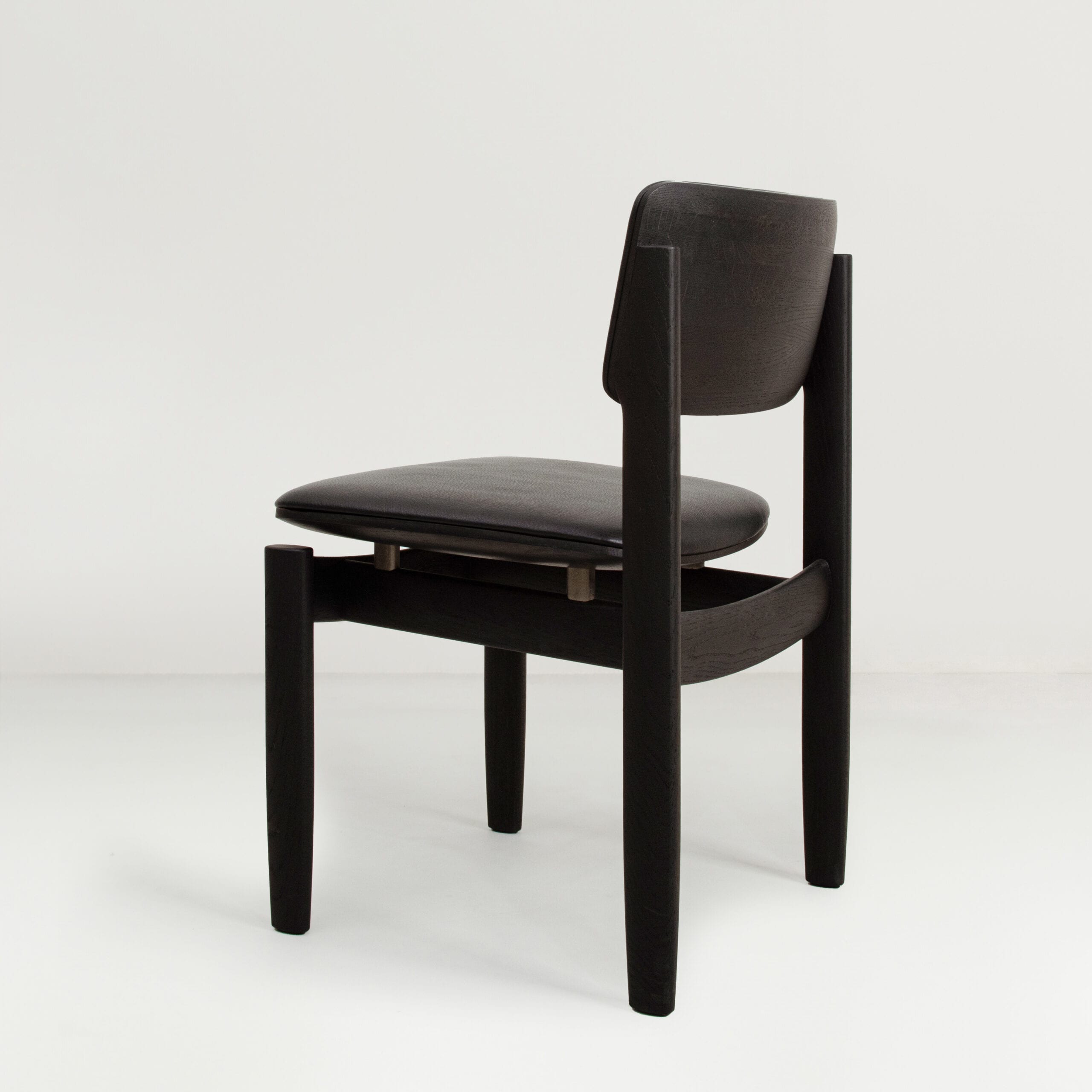 Side view of District Eight's Bow Chair highlighting the gravity-defying construction and ergonomic contours.