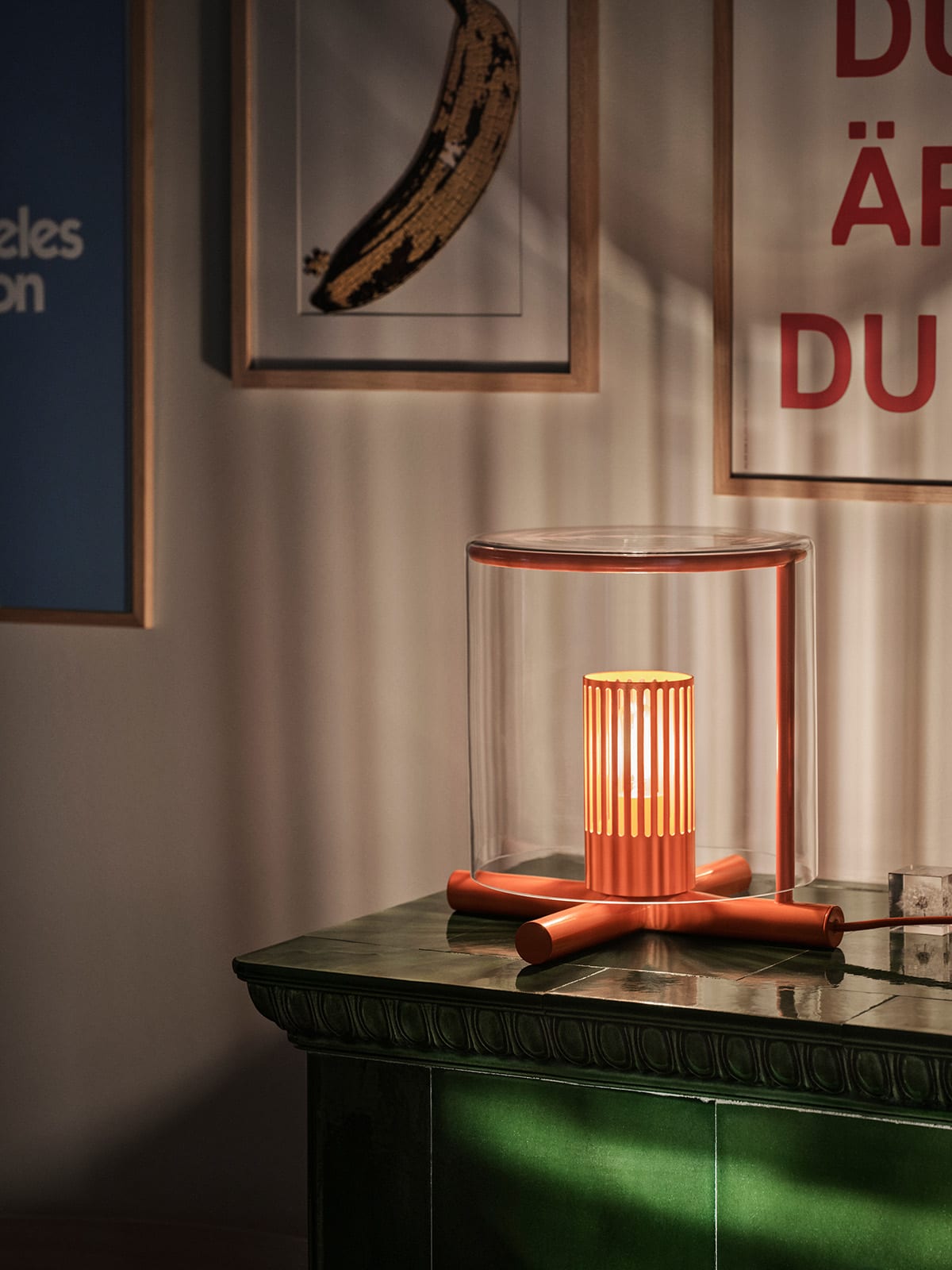 Fireplace Lamp used as a reading light on a side table, showcasing its practical application alongside its sculptural presence in a bedroom.