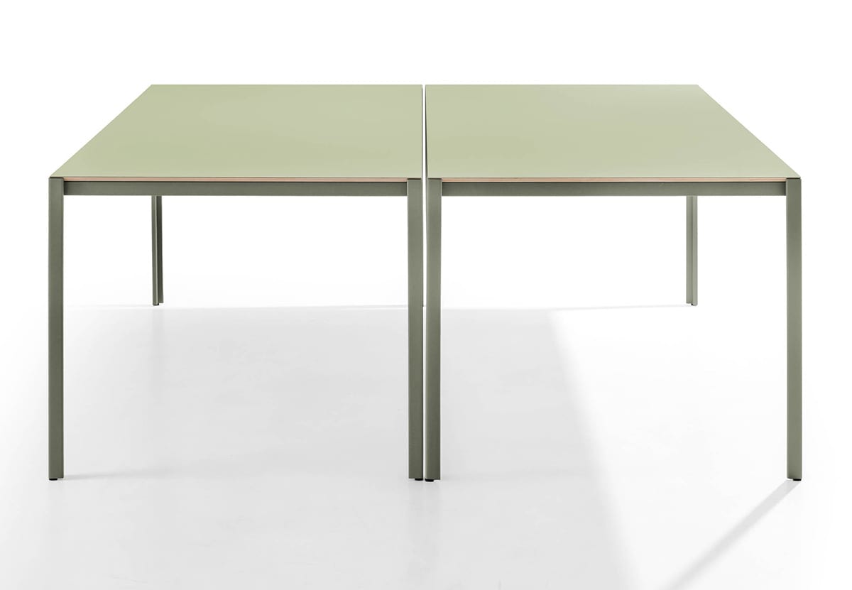 Architectural detail of Sarek's L-shaped metal leg design showcasing the elegant overlap with tabletop