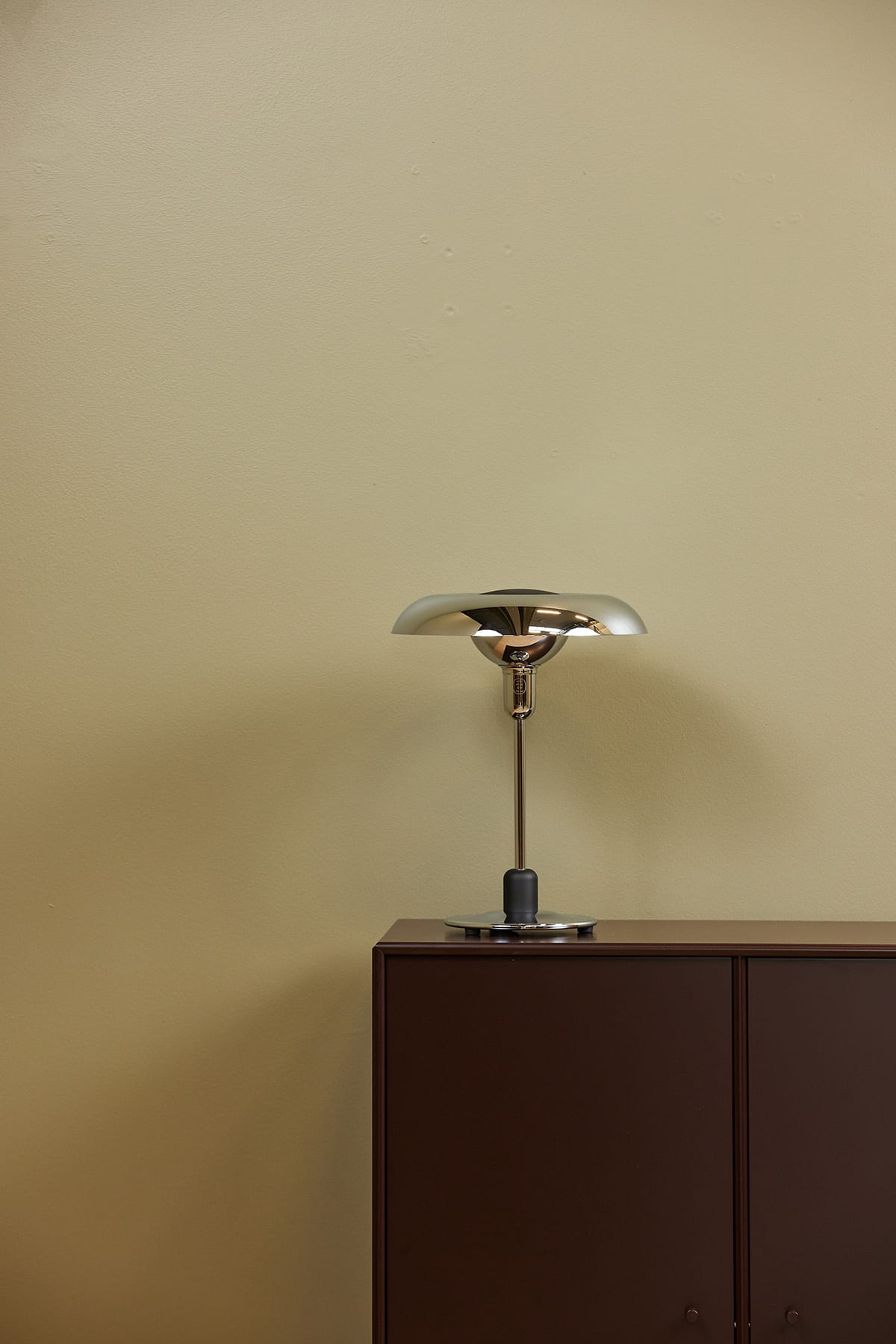 Piet Hein RA250 chrome lamp on designer desk creating focused work lighting with mathematical precision