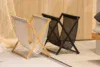Woodnotes Magazine Rack by Raffaella Mangiarotti and Ilkka Suppanen – oak frame with woven paper yarn bag
