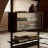 Fluted glass panel detail on Pira cabinet – tactile surface with visible interior display