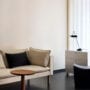 Upholstered components balance comfort with visual clarity. Refined seating depth and armrest height support extended use without excess padding.