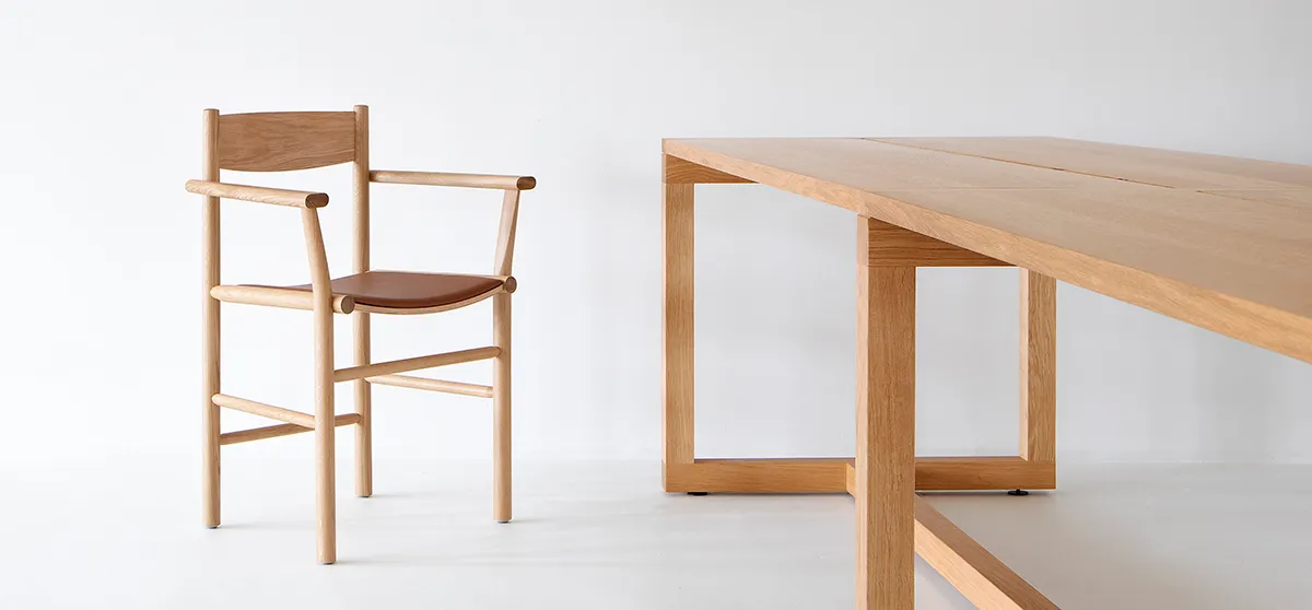 Akademia chair with armrests featuring curved seat and straight frame by Kaksikko for Nikari
