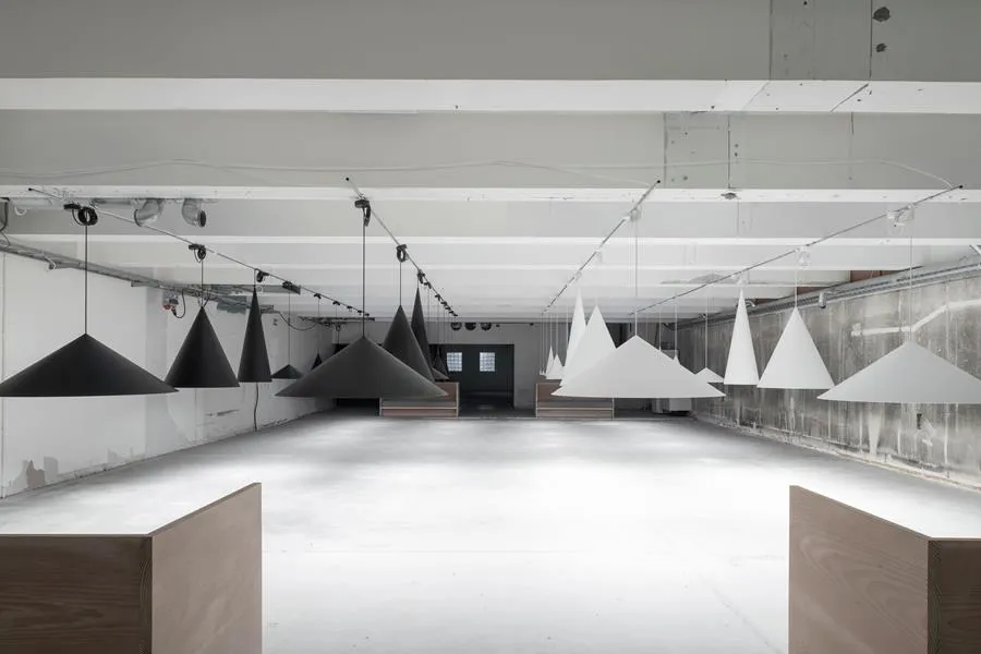 Complete W221 pendant installation showing multiple cone sizes and dramatic spatial lighting effects