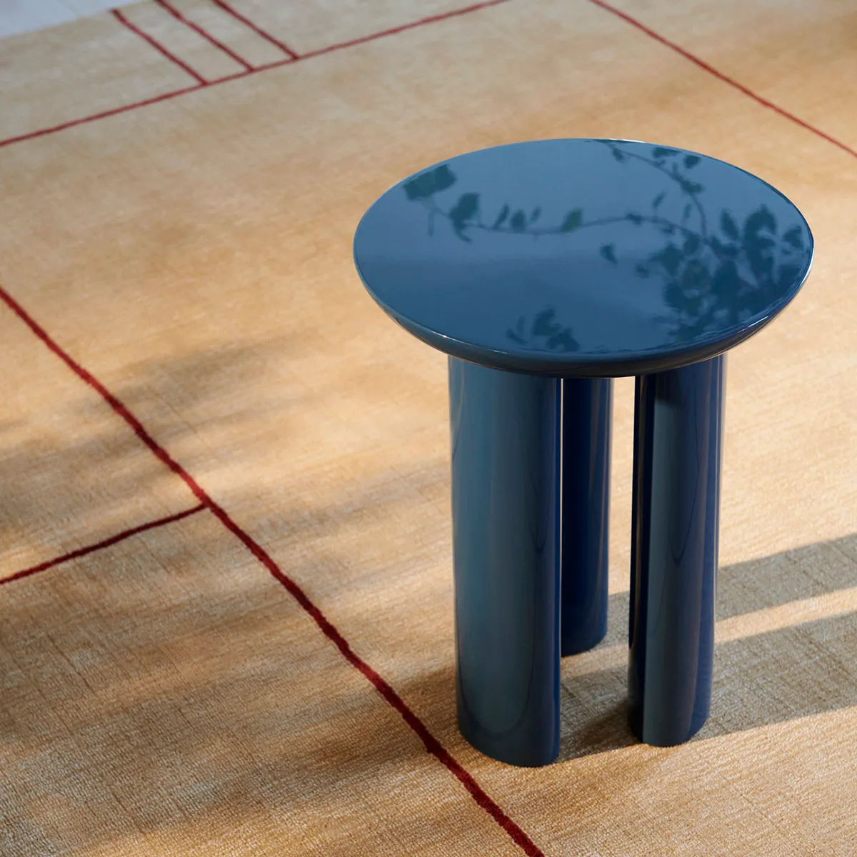 Tung JA3 side table by John Astbury for &Tradition showcasing monolithic strength with three pillar legs and round top