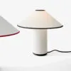 &tradition Colette table lamp featuring Art Deco inspired design with cotton-linen shade and brass details