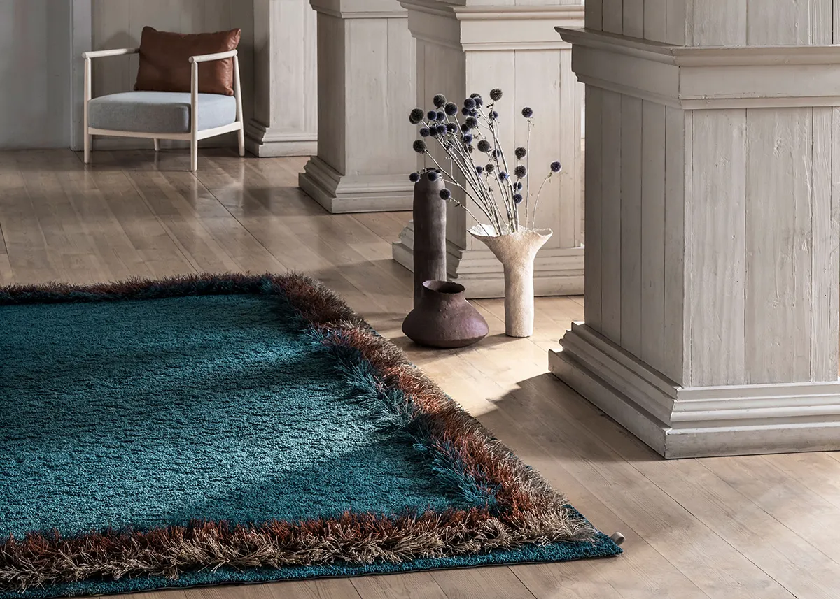 Kasthall Feather rug featuring hand tufted wool and linen construction with distinctive feather-like fringe border