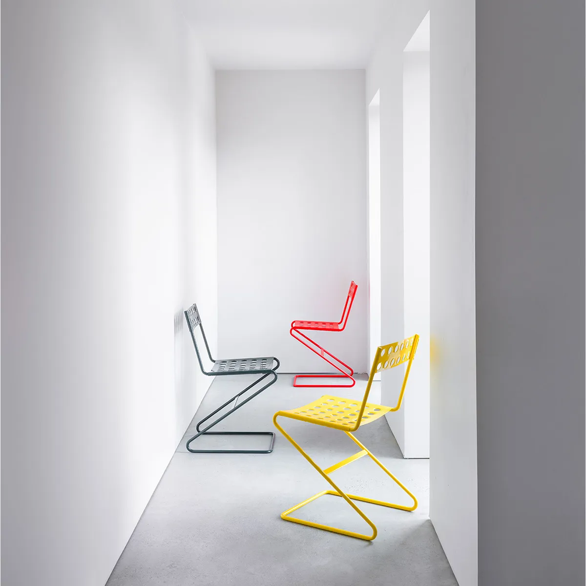 Zola chair collection displaying four color options including white red yellow and black powder coating finishes