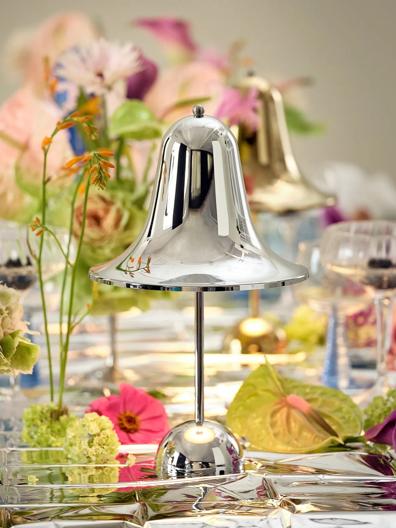 Pantop Portable chrome and brass table lamps by Verpan showing reflective metallic finishes and bell-shaped design