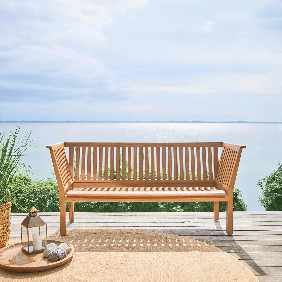 St. Catherine bench by Arne Jacobsen integrated in contemporary garden setting showing timeless versatility