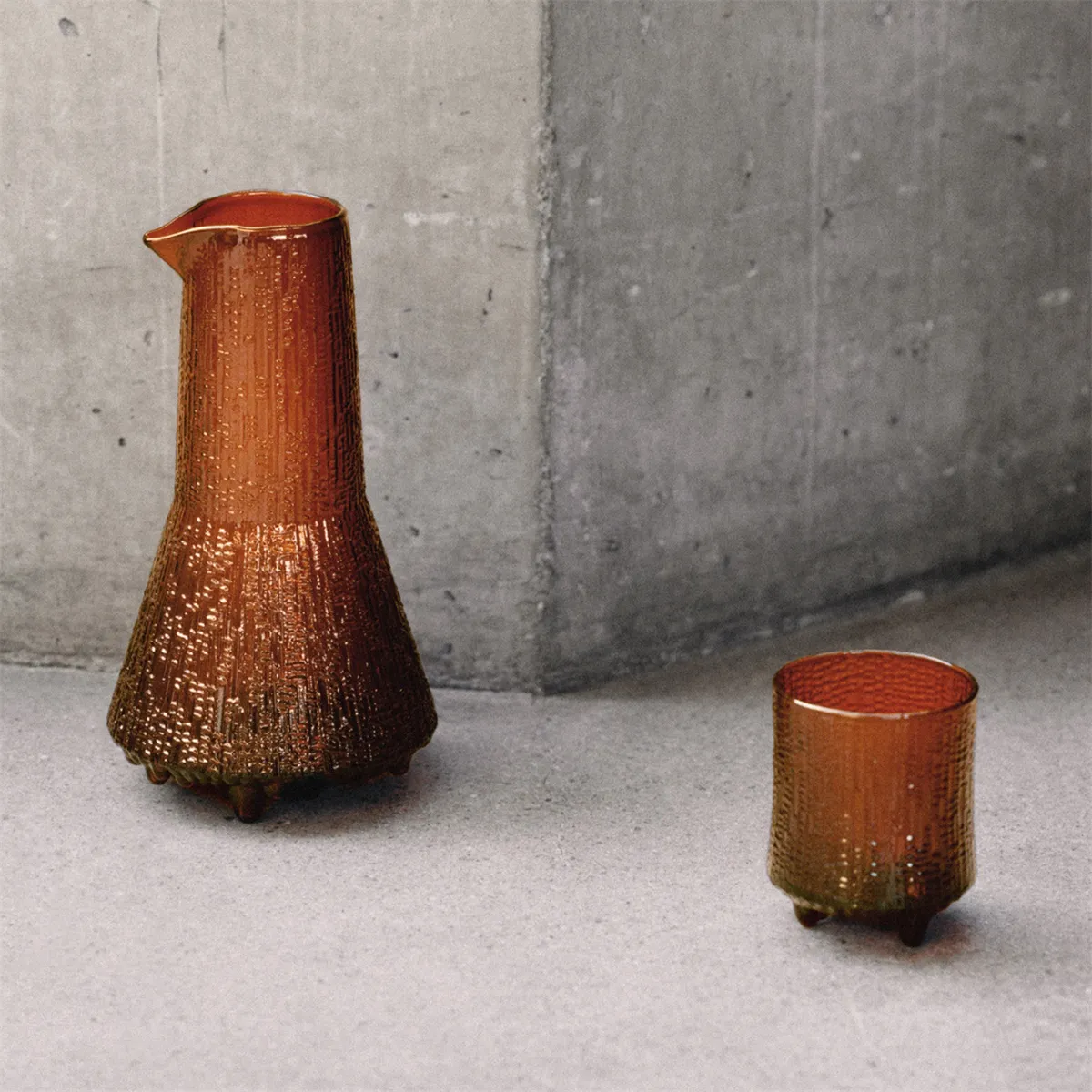 ULTIMA THULE old-fashioned glass and pitcher in special edition copper color showing Tapio Wirkkala's ice-inspired textured design