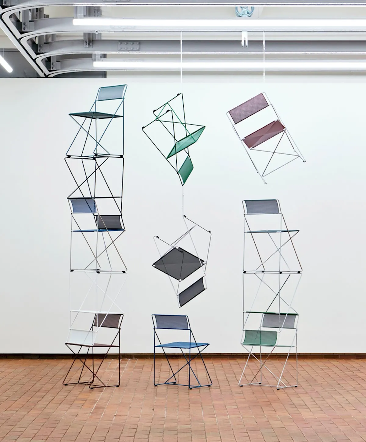 X-Line chair by Niels Jørgen Haugesen relaunched by HAY featuring minimalist tubular steel frame and distinctive X-shaped sides