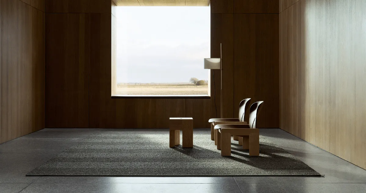 Sustainable luxury interior featuring Kasthall's groundbreaking Fasad collection rugs, designed by Sir David Chipperfield's team, demonstrating the elegant versatility of recycled wool in high-end design.
