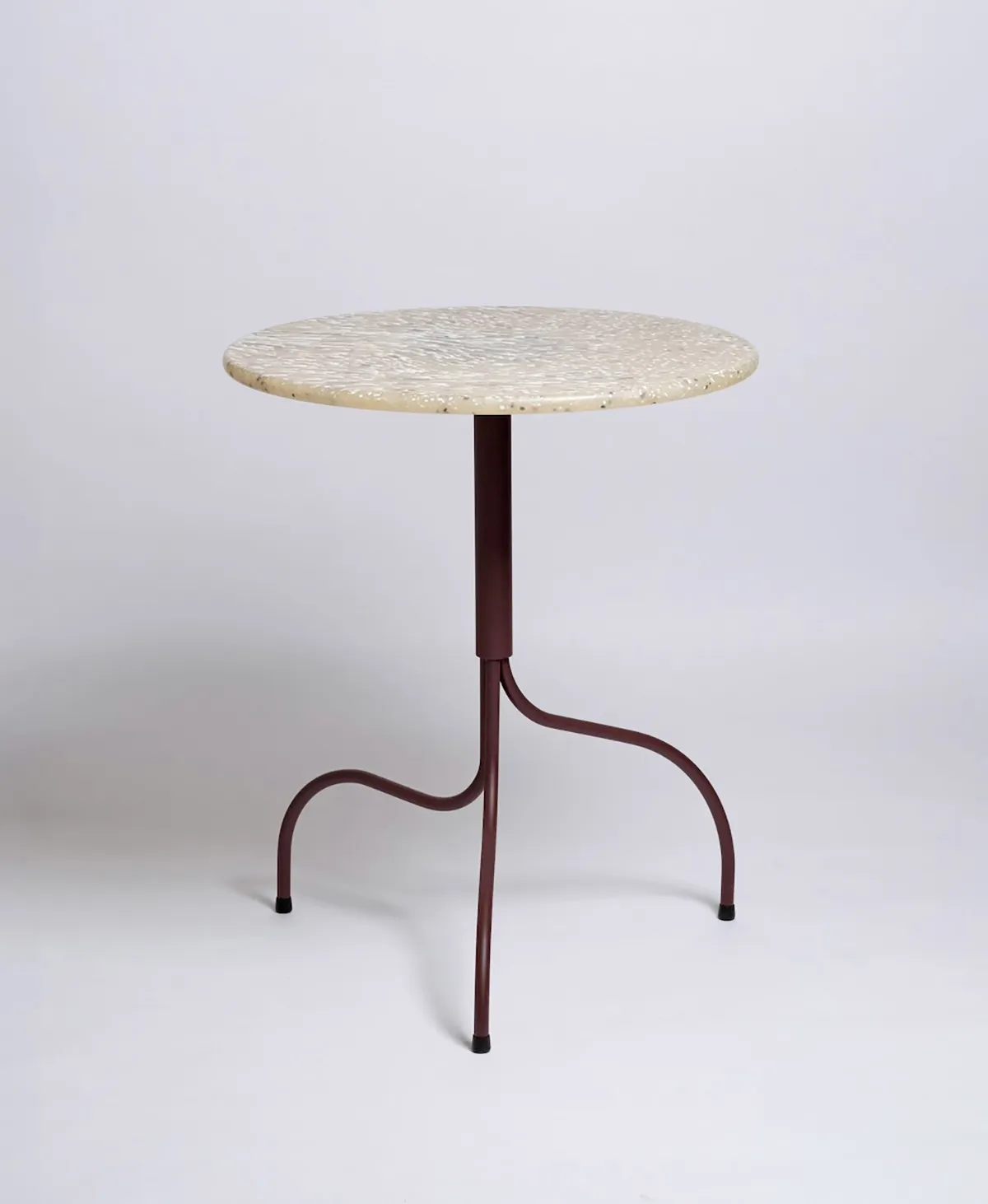 Close-up of Liv Tundra table's innovative surface made from reclaimed yogurt containers and food packaging, showcasing seaglass-like aesthetic and circular design principles