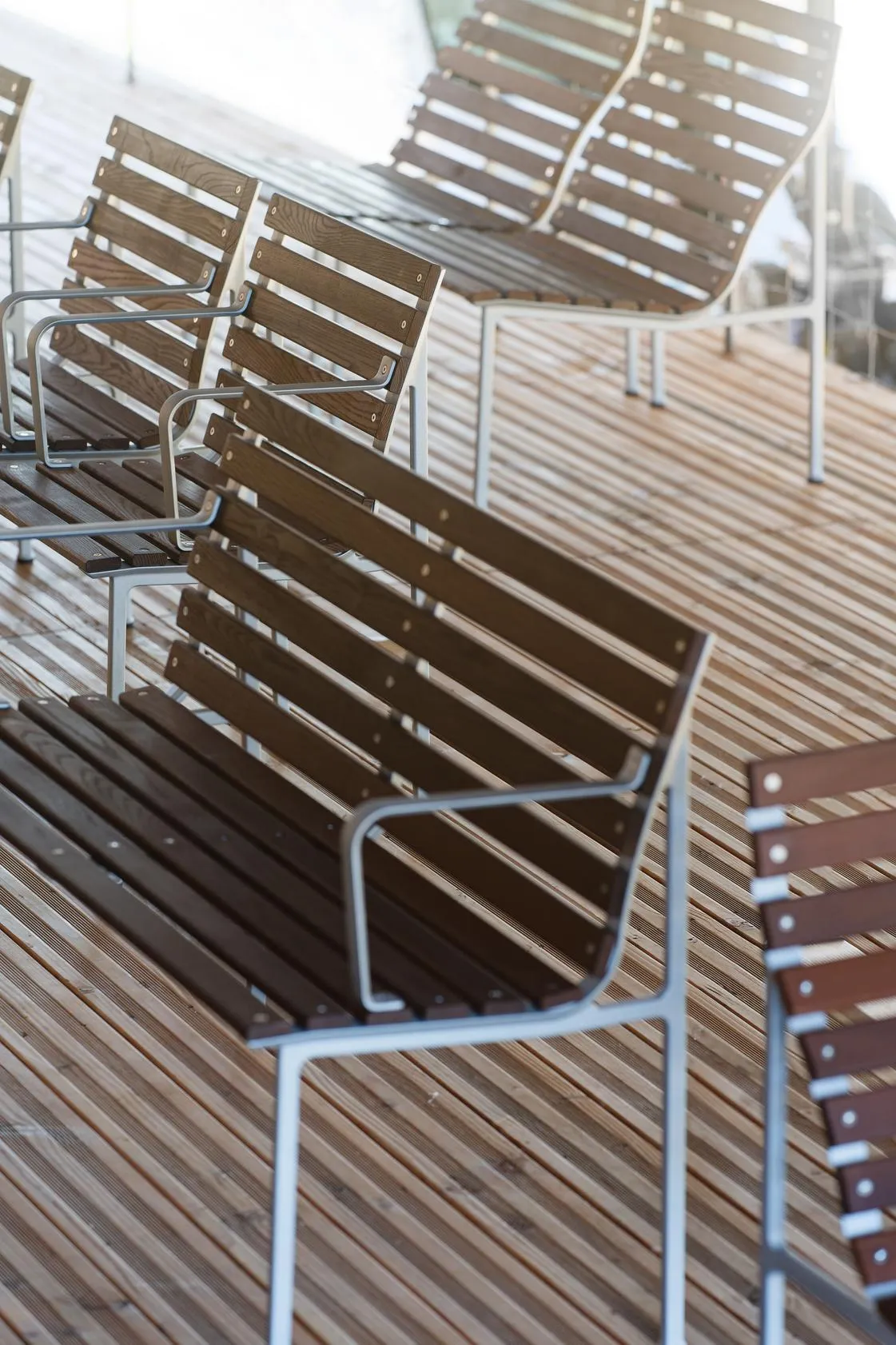 Erwan Bouroullec's Traverse bench with heat-treated ash slats in public garden setting