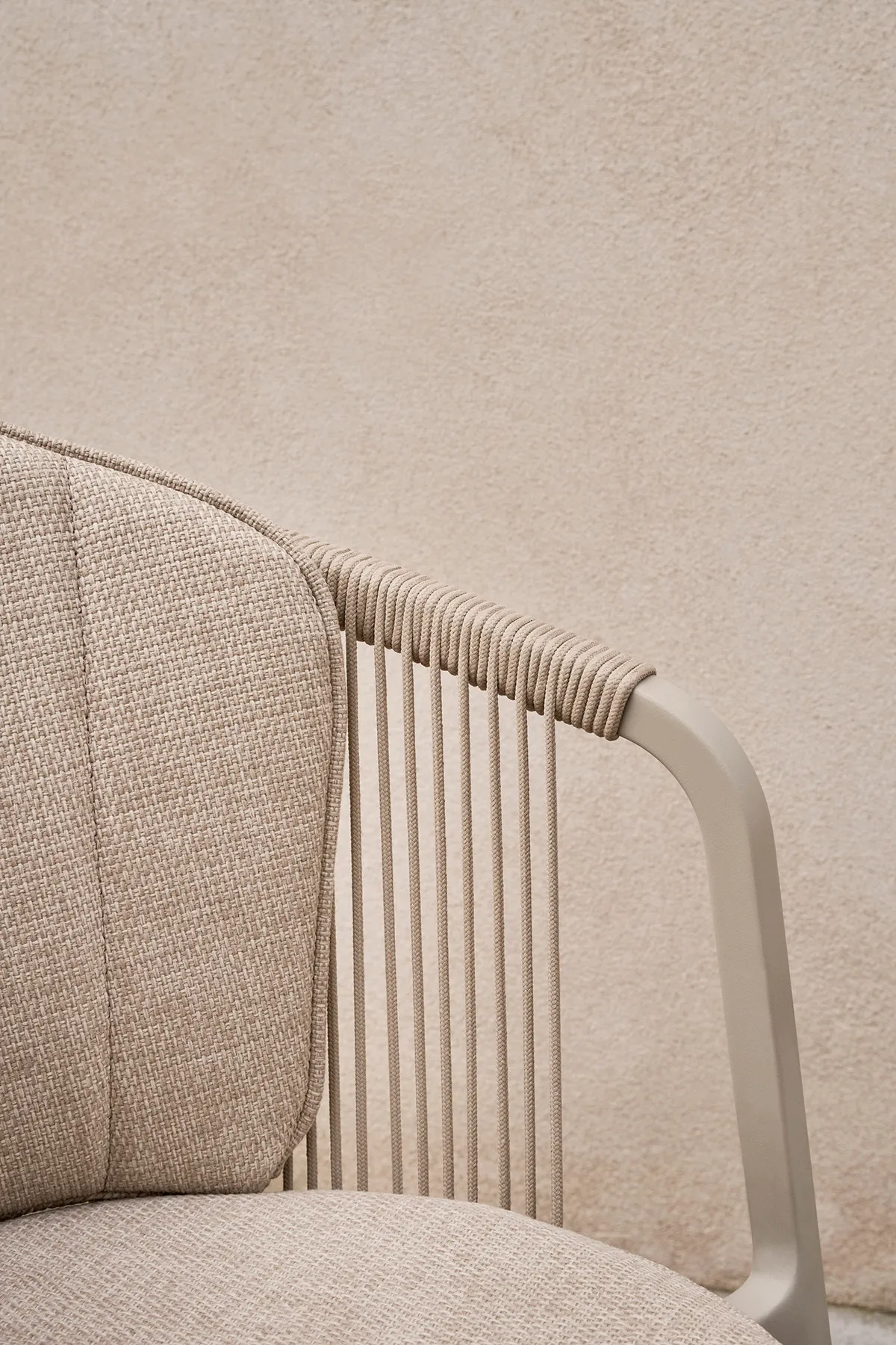 Vipp Lagrasse dining chair with curved backrest extending into armrests, designed for comfortable outdoor use