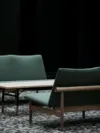 Japan Sofa by Finn Juhl featuring minimalist wooden frame with horizontal backrest and clean upholstered seating in contemporary setting.