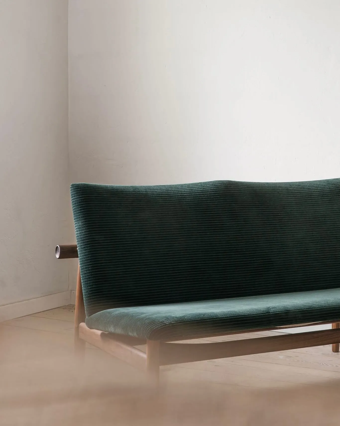 Japan Sofa showing the distinctive circular recess detail where backrest meets frame, highlighting Finn Juhl's craftsmanship.