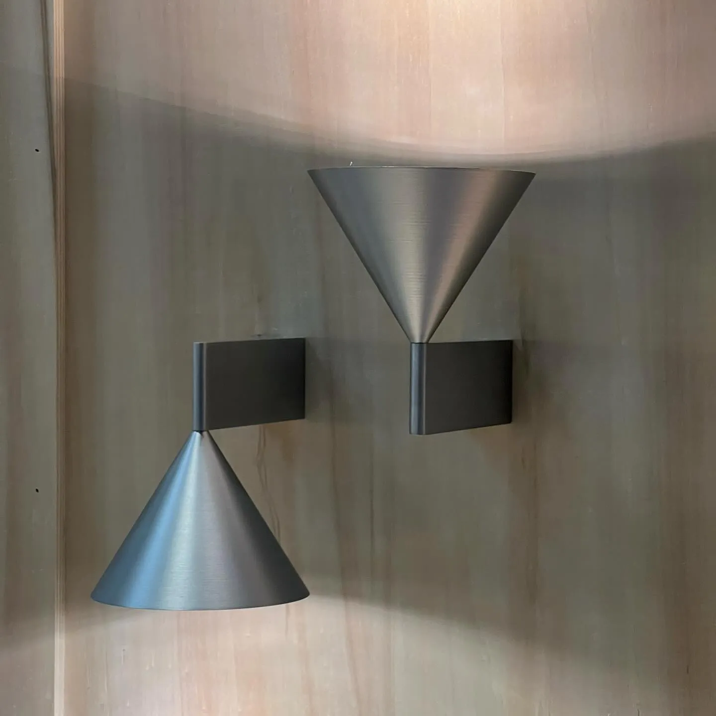 Close-up of Apollo lamp's precision-machined brass connection point where conical shapes meet to create visual tension and balance.