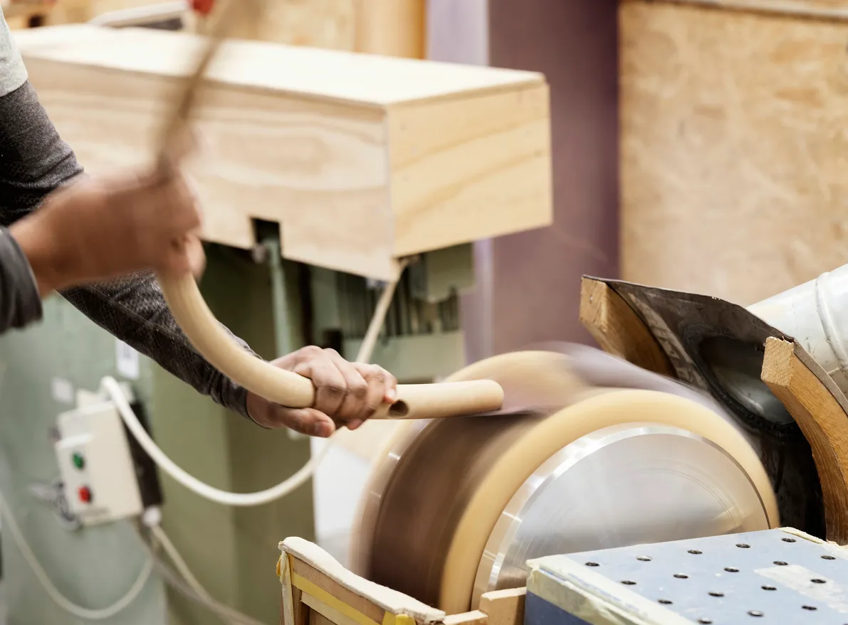 Carl Hansen & Søn craftsman hand-finishing an authentic Wishbone Chair in the company's Danish workshop