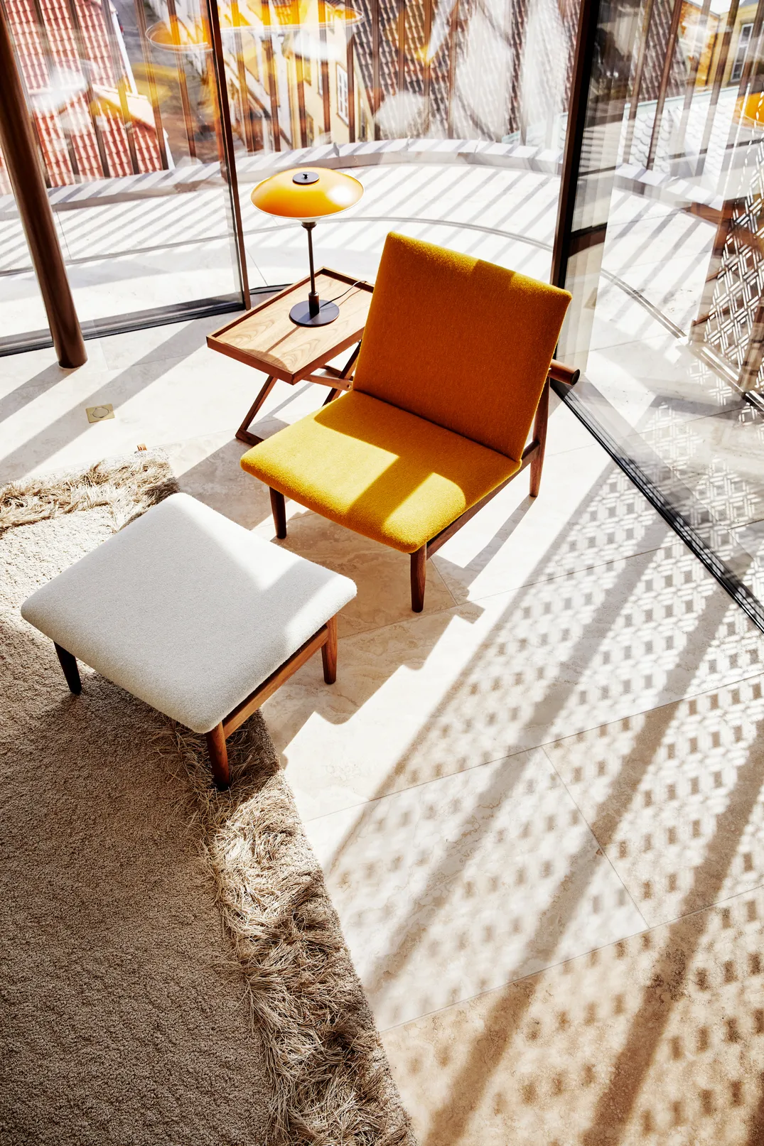 Japan chair in dark walnut with upholstery creating focal point in mid-century inspired interior with natural materials. Photo: Lars Petter Pettersen