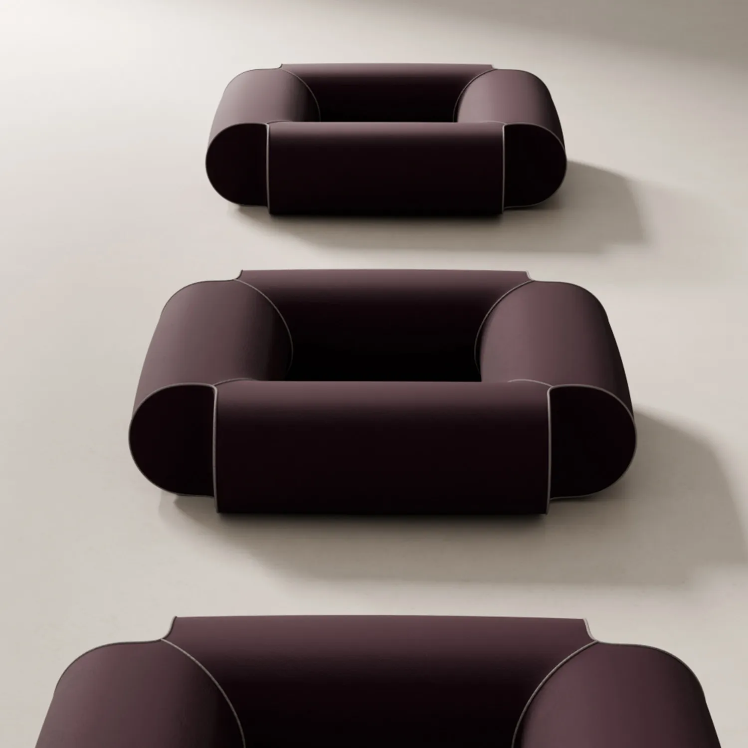 Geometric seating design cylindrical furniture forms minimalist aesthetic upholstered piping details floating base