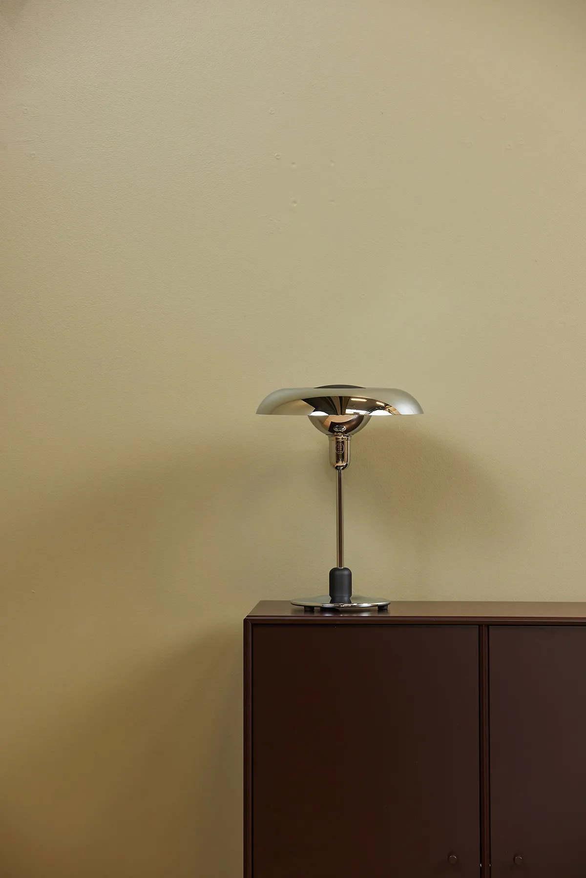 Piet Hein RA250 chrome lamp on designer desk creating focused work lighting with mathematical precision