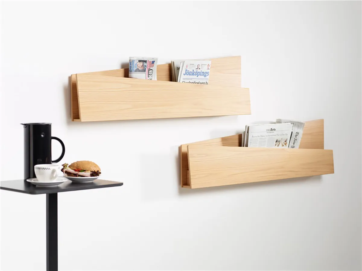 Louise Hederström Collar magazine storage system for Karl Andersson Söner featuring angled folded paper design