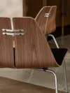 Poul Kjaerholm PK23 lounge chair in natural finish showcasing democratic design approach and accessibility