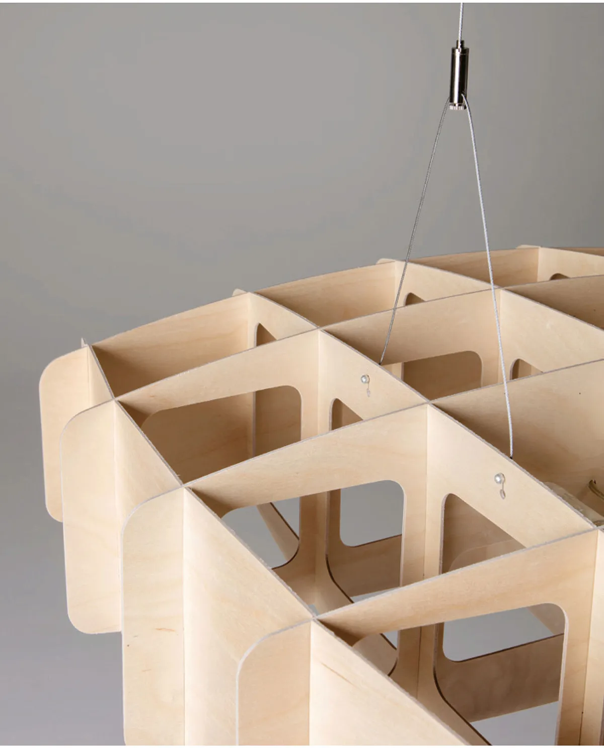 Close-up geometric lattice pattern of Ristikko birch plywood pendant showing Finnish craftsmanship detail