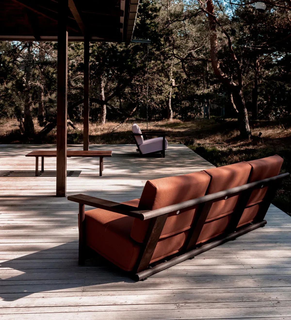 David Ericsson's complete Baba Collection showcasing the 3-seater sofa, easy chair, sideboard, and table in heat-treated ash. The wide armrests are designed to comfortably hold drinks, while the outdoor-suitable ash construction offers versatility for any environment