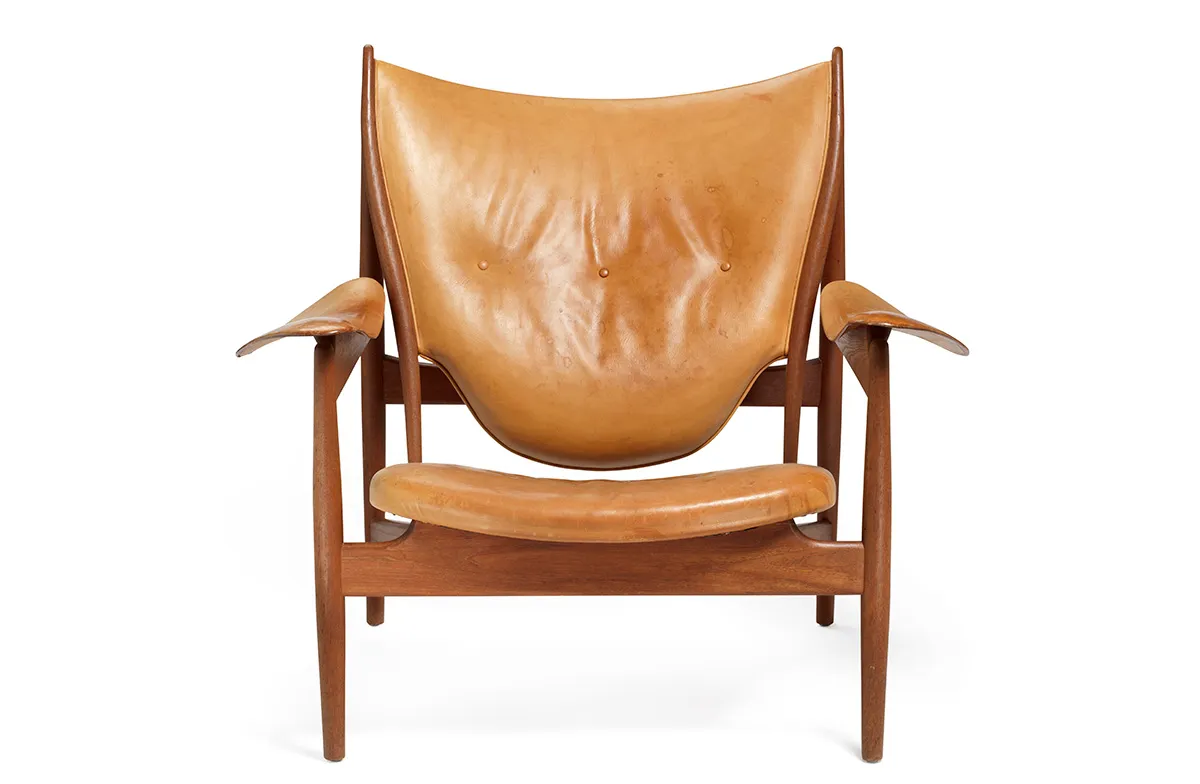 profile of Finn Juhl Chieftain Chair displaying sculptural form and patinated natural leather upholstery