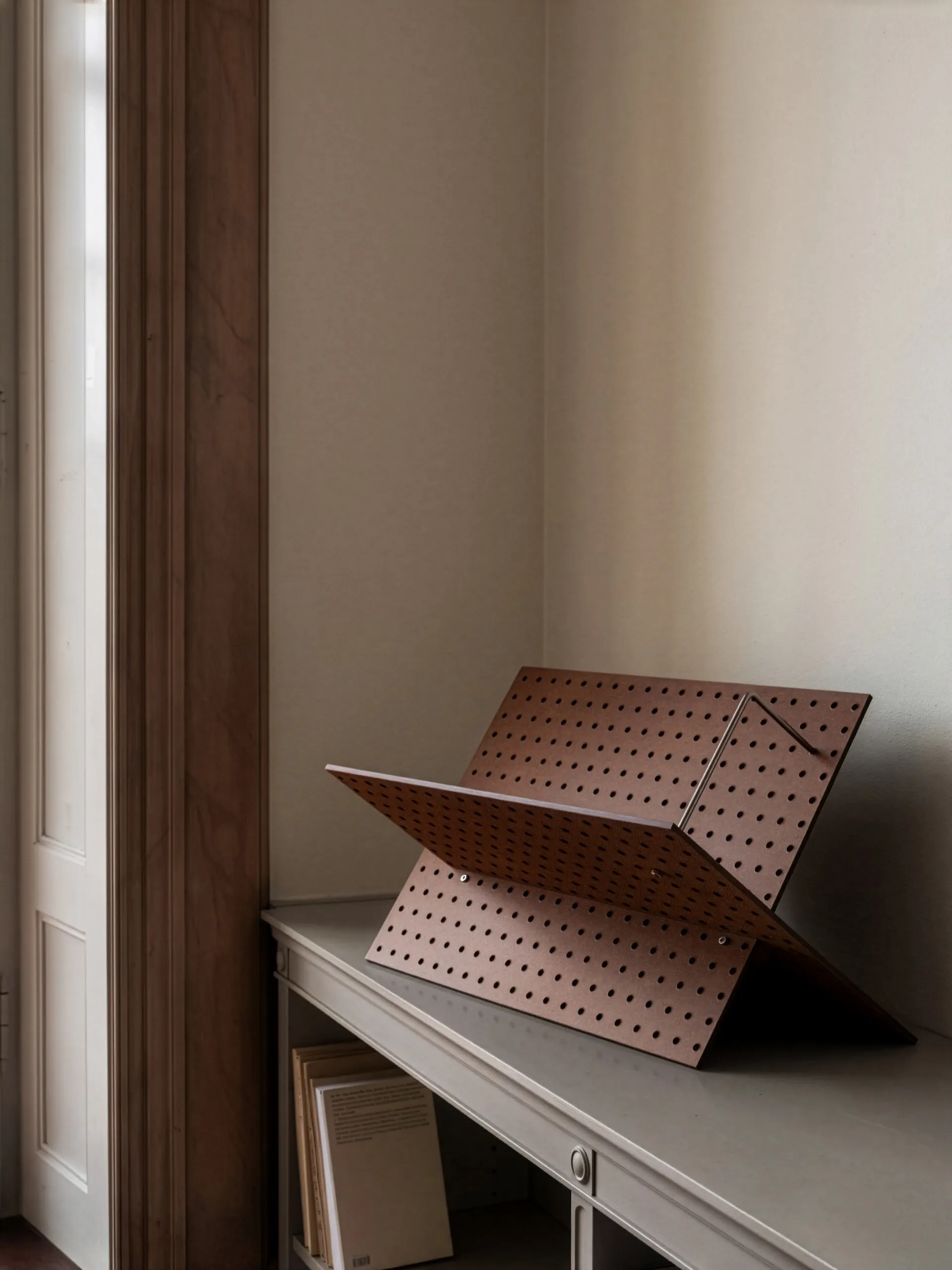 The Perforated Furniture book cradle by Folkform displayed in Stockholm showroom