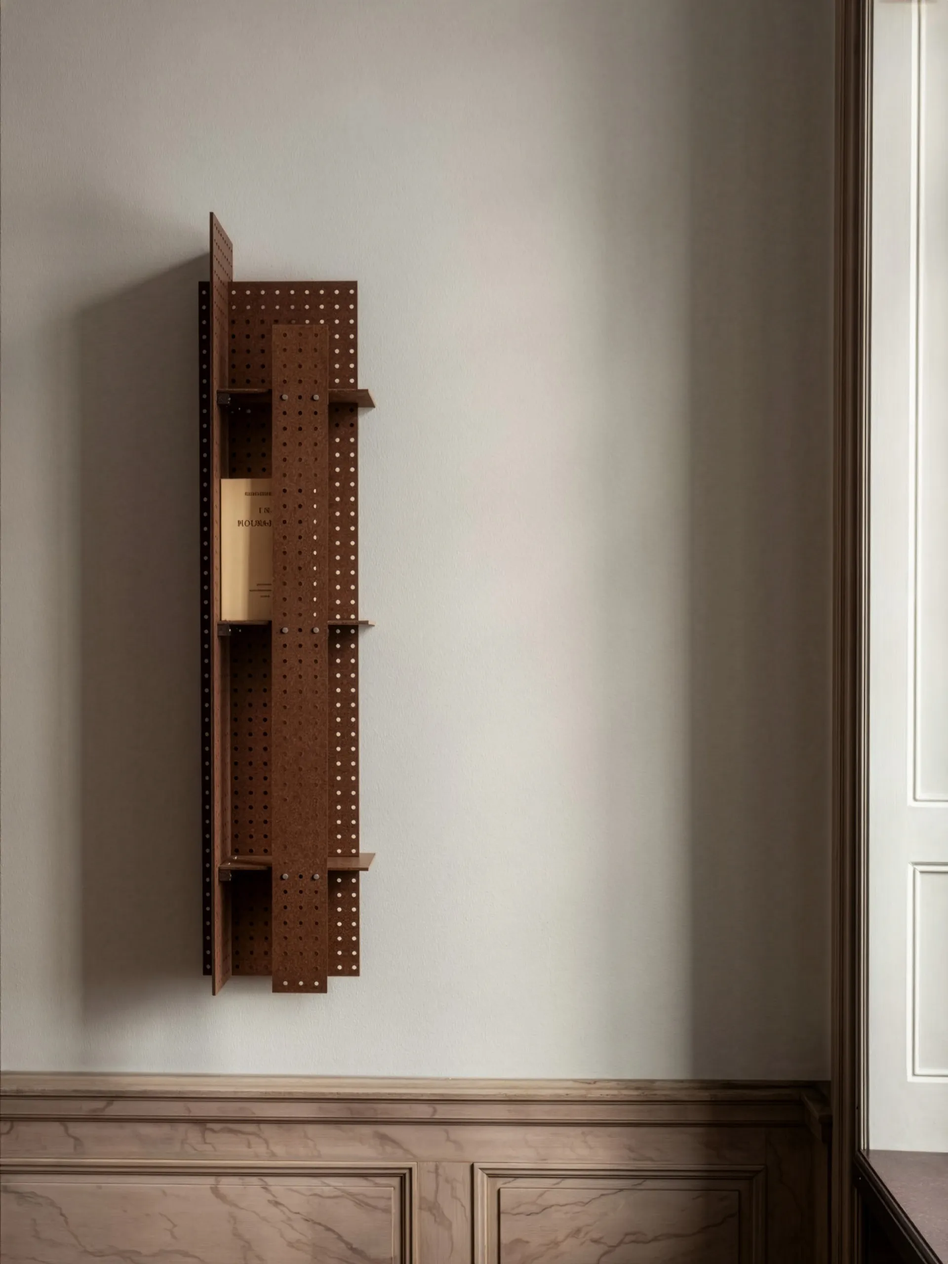 Wall-mounted shelf from Folkform's Perforated Furniture series installed in interior setting