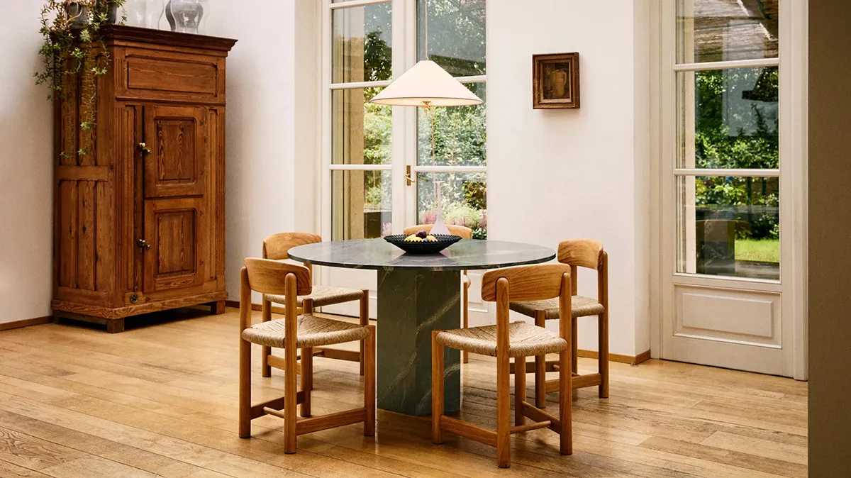 Daumiller Armchair and Side Chair collection by GUBI, showcasing both golden pine and brown/black-stained finish options.