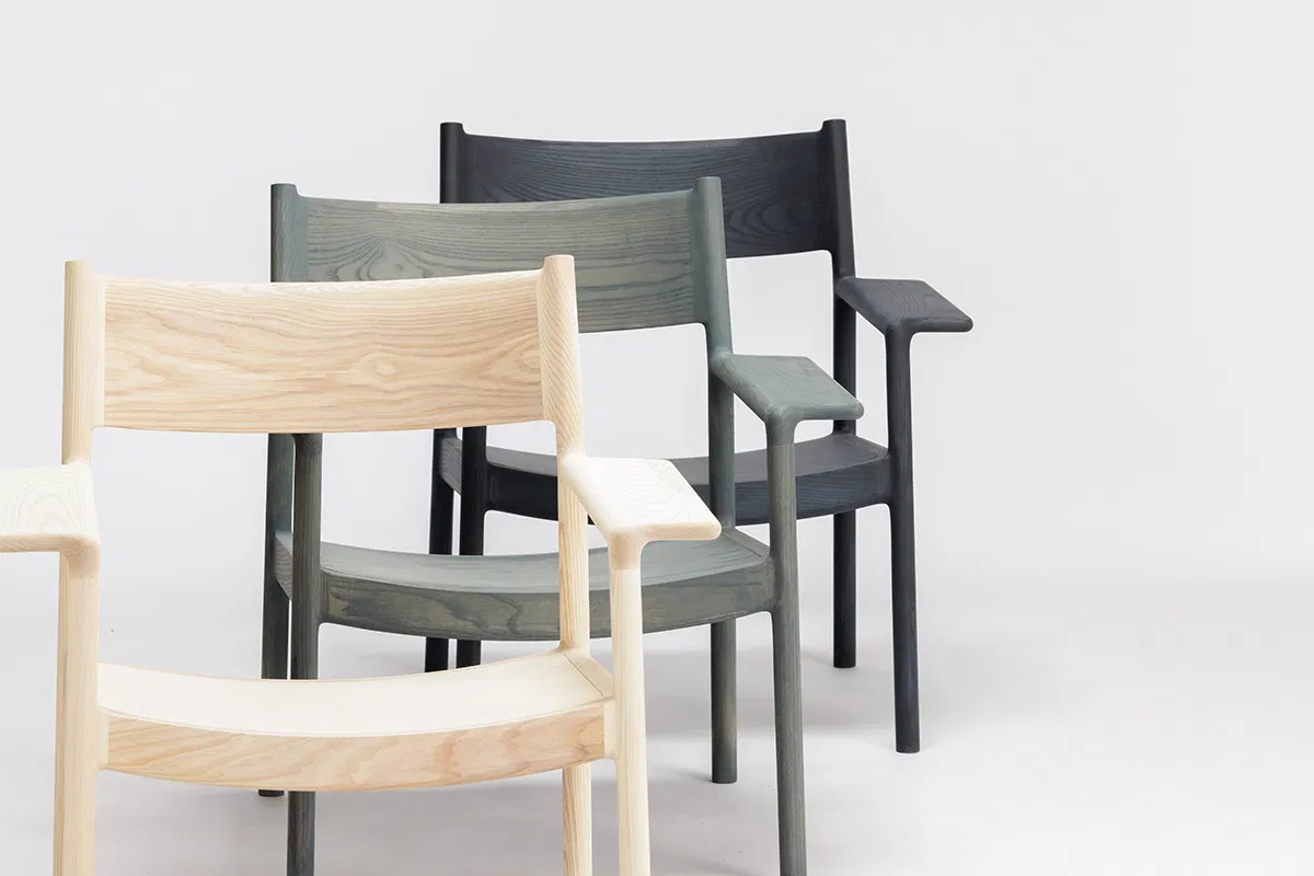 Hirata Gen Collection featuring the new GLC 01 lounge chair alongside complementary furniture pieces in various wood finishes.