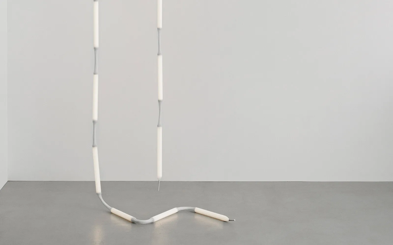 Reb Lamp by Verena Hennig for Normann Copenhagen displayed as a minimalist lighting installation with eight illuminated modules.