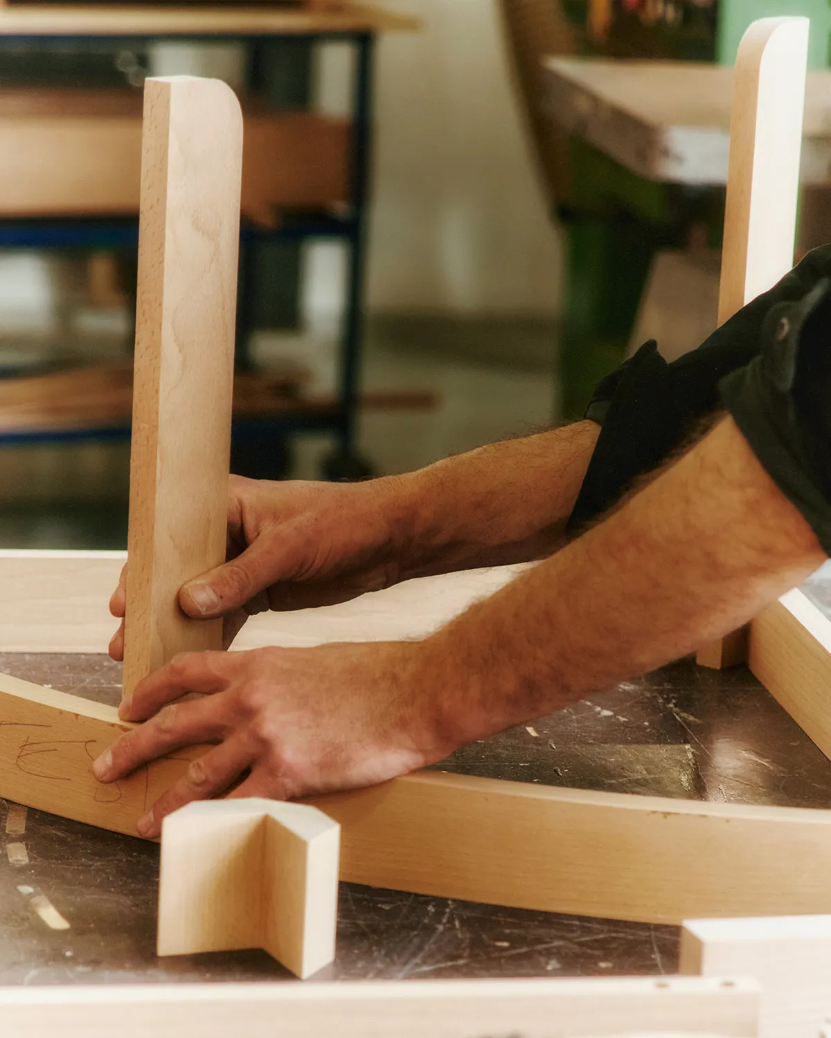 Danish workshop craftsmen assembling Nanna Ditzel bench using traditional woodworking techniques