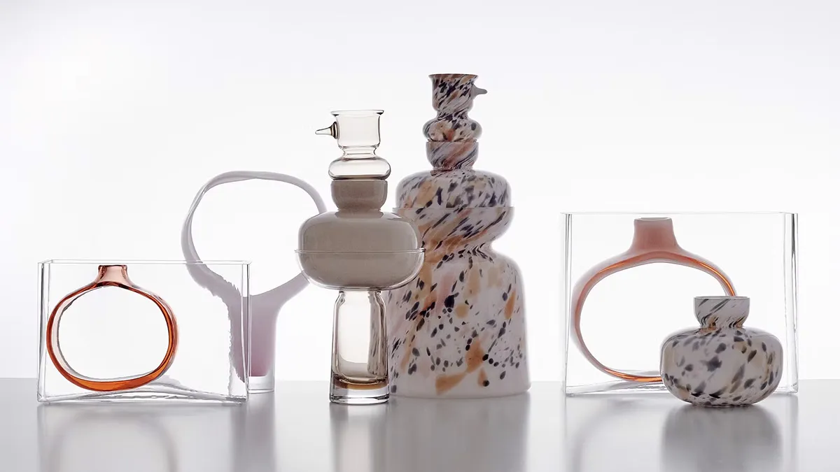 Multiple glass sculptures by Matti Klenell displayed in gallery setting showing varied forms and transparency