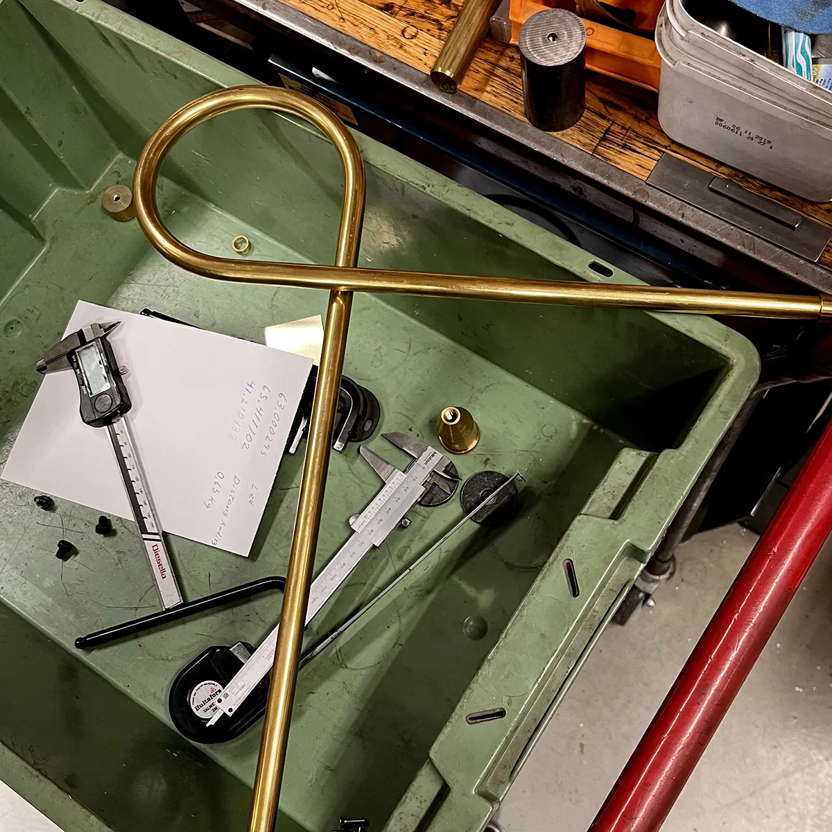 Close-up of LOOP lighting fixture showing raw brass construction and circular design element detail