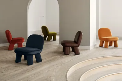 Transformed Maximus easy chair by Johan Ansander for Blå Station, evolving from all-wood construction to springy lushness.