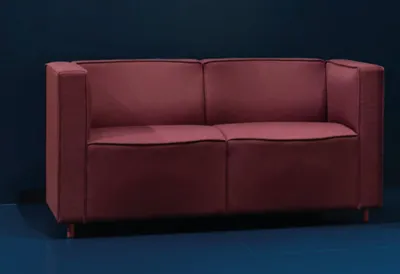 Pauline Deltour stylized sofa collection by Offecct featuring tailored fabric wrapping and elegant proportions